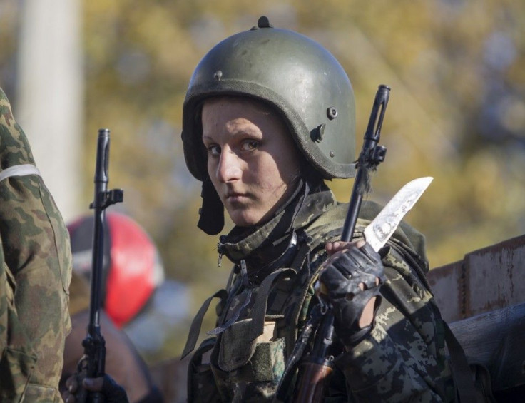 A female pro-Russian rebel stands on a truck as she gets ready to take position near the Sergey Prokofiev International Airport during fighting with Ukrainian government forces in the town of Donetsk, eastern Ukraine, October 4, 2014. Before fighting brok