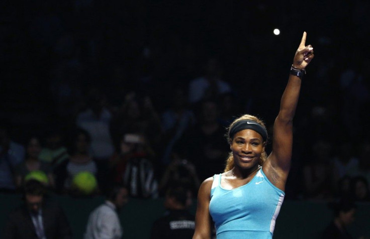 Serena Williams of the U.S. celebrates her victory against Ana Ivanovic of Serbia during their WTA Finals singles tennis match in Singapore October 20, 2014. REUTERS/Edgar Su