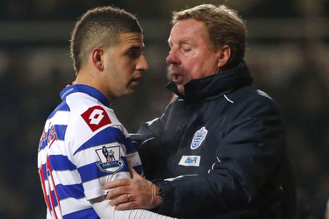 Queens Park Rangers manager Harry Redknapp (R) talks to Adel Taarabt as he is substituted during their English Premier League soccer match against West Ham United at Upton Park in London
