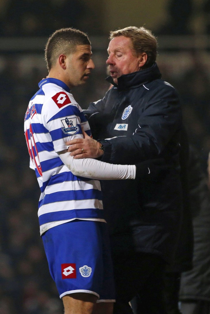 Queens Park Rangers manager Harry Redknapp (R) talks to Adel Taarabt as he is substituted during their English Premier League soccer match against West Ham United at Upton Park in London