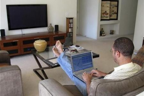 A man works on his laptop computer in his home