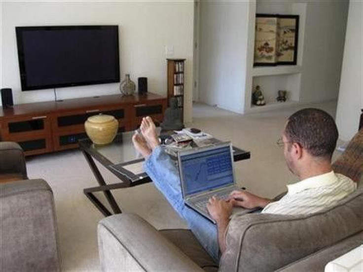 A man works on his laptop computer in his home