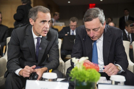 Bank of England Governor Mark Carney (L) and European Central Bank Governor Mario Draghi speak before a meeting of the International Monetary and Financial Committee (IMFC) at the World Bank/IMF annual meetings in Washington October 11, 2014.