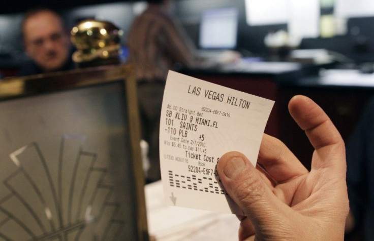 A gambler shows his ticket after making a bet on Super Bowl XLIV at the Las Vegas Hilton sports book in Las Vegas, Nevada, February 4, 2010. REUTERS/Las Vegas Sun/Steve Marcus