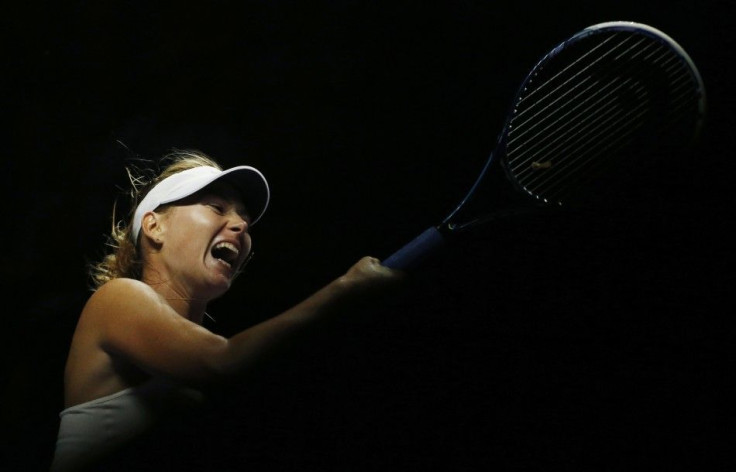 Maria Sharapova of Russia hits a return to Caroline Wozniacki of Denmark during their WTA Finals singles tennis match at the Singapore Indoor Stadium October 21, 2014. REUTERS/Edgar Su