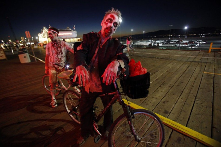 Dale Newman (R) and Paul Martella are dressed as zombies as they take part in a zombie crawl during Halloween in Santa Monica, California October 31, 2013. REUTERS/Mario Anzuoni