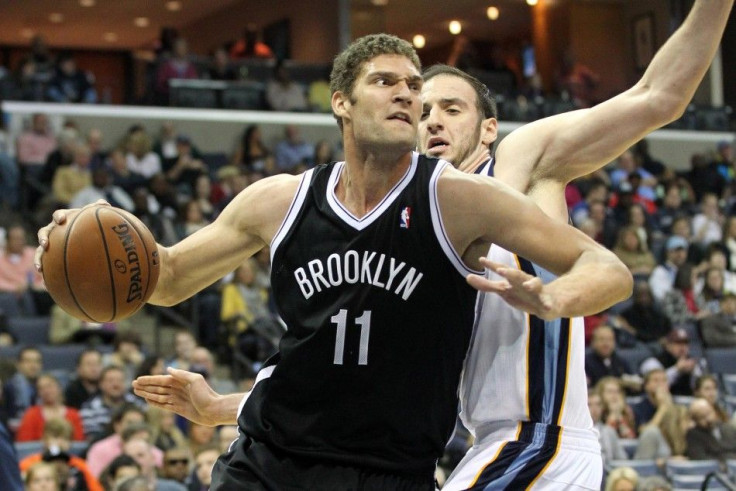 Brooklyn Nets center Brook Lopez (11) drives against Memphis Grizzlies center Kosta Koufos (41) during the first quarter at FedExForum.