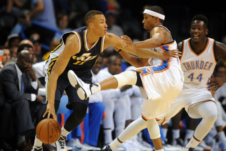 Oklahoma City, OK, USA Utah Jazz guard Dante Exum (11) handles the ball while being guarded by Oklahoma City Thunder guard Sebastian Telfair (31) during the third quarter at Chesapeake Energy Arena.