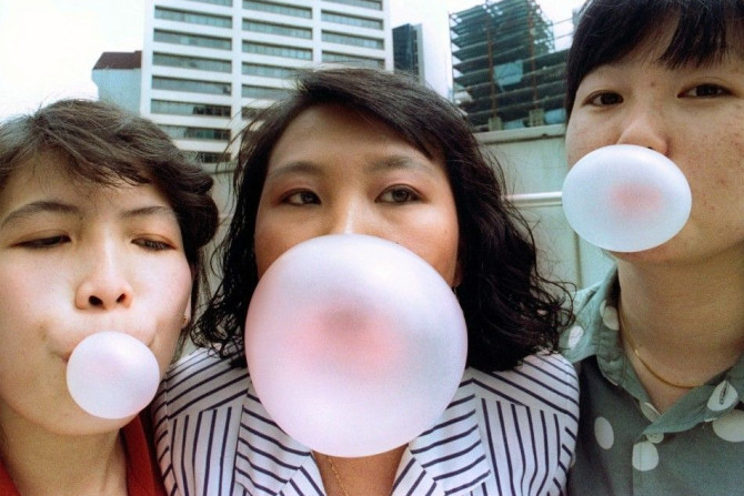 Singaporeans pose while blowing bubbles in this early January 1992 photograph