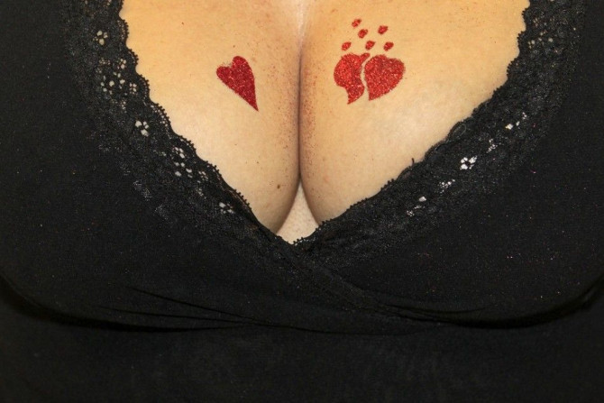A stallholder displays her temporary tattoos on sale at the adult entertainment exhibition Erotica 2010 at Olympia centre in London November 20, 2010.