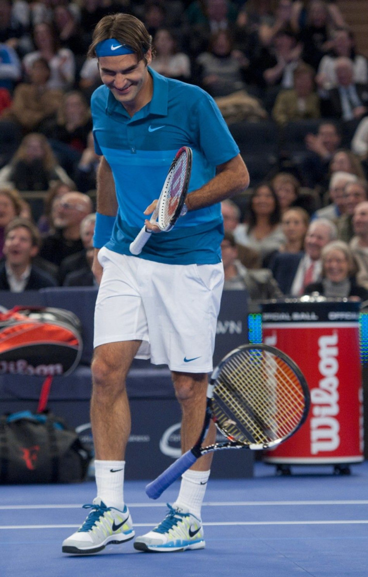 Roger Federer of Switzerland dodges a tennis racket thrown by Andy Roddick of Britain after he won a point in the 2012 BNP Paribas Showdown at Madison Square Garden in New York March 5, 2012. REUTERS/Ray Stubblebine