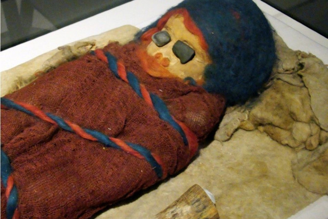 The mummified remains of an infant, with blue stones covering its eyes, is displayed at the Houston Museum of Natural Science in Texas