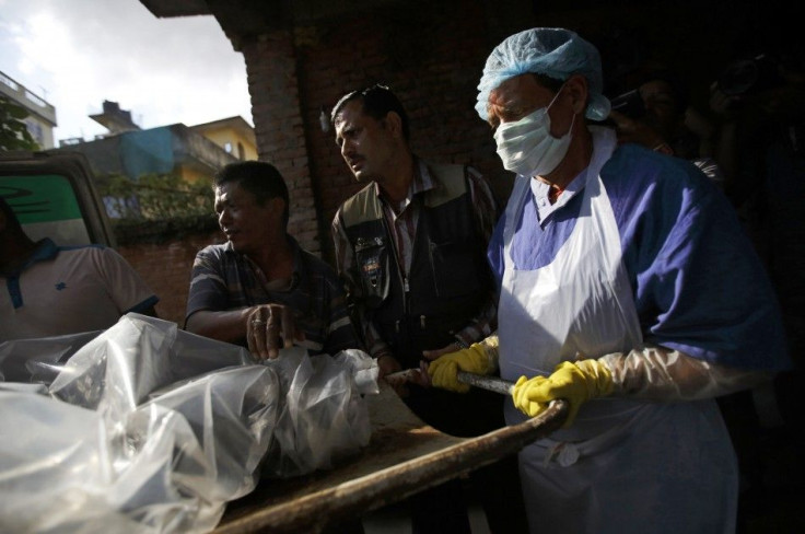 The body of a victim is moved from an ambulance to the morgue after it was brought back from Annapurna Region in Kathmandu