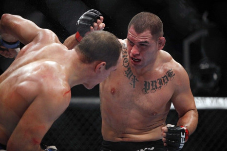 Oct 19, 2013; Houston, TX, USA; Cain Velasquez (red gloves) fights against Junior Dos Santos (blue gloves) in the world heavyweight championship bout during UFC 166 at Toyota Center