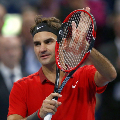 Roger Federer of Switzerland celebrates after defeating Denis Istomin of Uzbekistan at the Swiss Indoors ATP tennis tournament in Basel October 23, 2014. REUTERS/Arnd Wiegmann