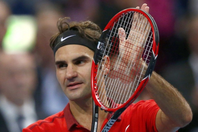 Roger Federer of Switzerland celebrates after defeating Denis Istomin of Uzbekistan at the Swiss Indoors ATP tennis tournament in Basel October 23, 2014. REUTERS/Arnd Wiegmann