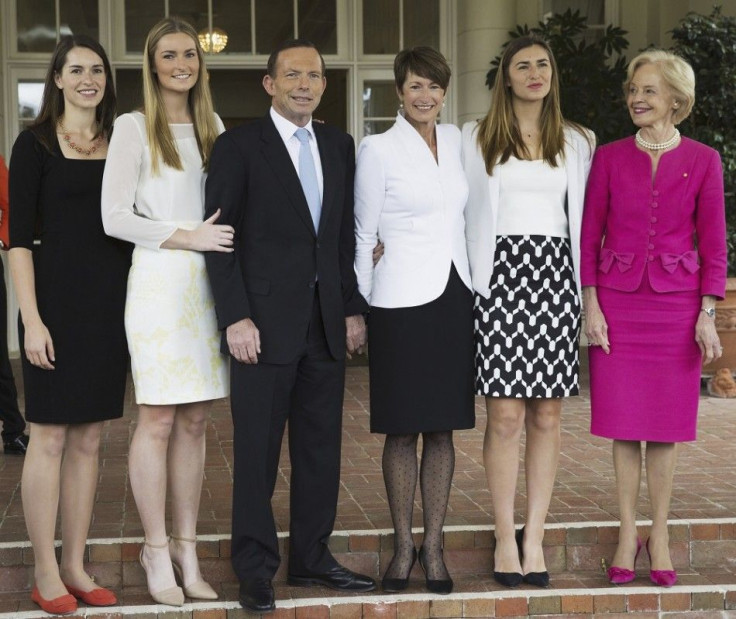 The new Prime Minister of Australia Tony Abbott (3rd L) poses with his daughters Louise (2nd R), Bridget (2nd L), Frances (L), his wife Margie and the Governor-General Quentin Bryce (R) after the official swearing in of government ministers at the Governm