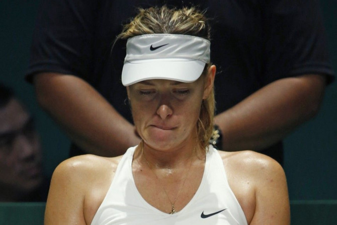 Maria Sharapova of Russia rests in between games in the second set against Petra Kvitova of the Czech Republic during their WTA Finals tennis match at the Singapore Indoor Stadium October 23, 2014. REUTERS/Edgar Su