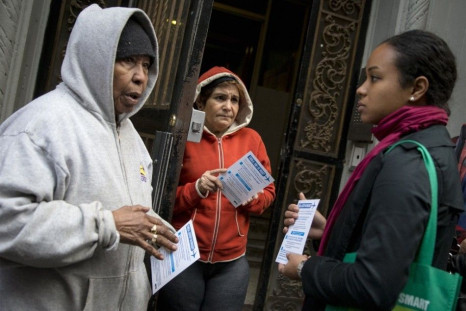 A member of the New York City Department of Health (R) speaks to neighbors of Dr. Craig Spencer in the Hamilton Heights area of Harlem in New York, October 23, 2014. Spencer, who worked in West Africa with Ebola patients, tested positive for Ebola and was