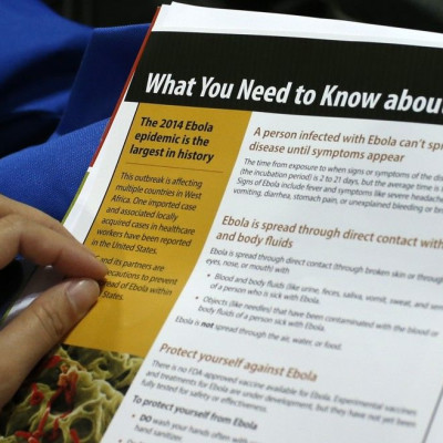 A woman reads a pamphlet as New York Healthcare workers attend an Ebola educational session at the Jacob Javits Convention center in New York, October 21, 2014. Thousands of healthcare workers representing dozens of clinical and non-clinical positions att