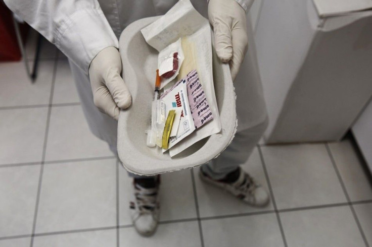 A paramedic holds a kit containing syringes, bandaids and antiseptic pads which are going to be used by drug addicts inside a supervised injection room in Athens November 25, 2013. Greece has set up its first &quot;drug consumption&quot; room to contain a