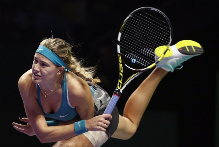 Eugenie Bouchard of Canada serves to Serena Williams of the U.S. during their WTA Finals singles tennis match at the Singapore Indoor Stadium October 23, 2014. REUTERS/Edgar Su