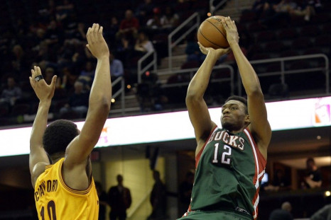 Oct 14, 2014; Cleveland, OH, USA; Milwaukee Bucks forward Jabari Parker (12) shoots over Cleveland Cavaliers guard Chris Crawford (10) in the fourth quarter at Quicken Loans Arena.
