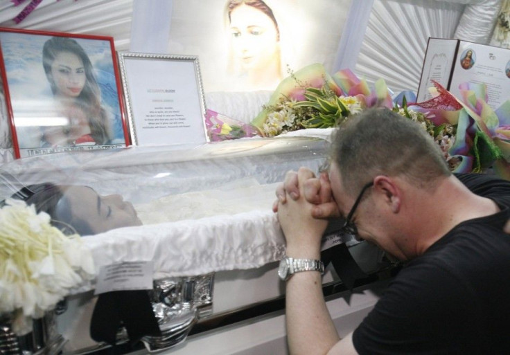 German national Marc Sueselbec grieves beside the coffin of his fiancee, slain transgender Jennifer Laude, in Olongapo city north of Manila October 20, 2014. The Philippines on Friday issued a summons for an American serviceman, U.S. Marine Joseph Scott P