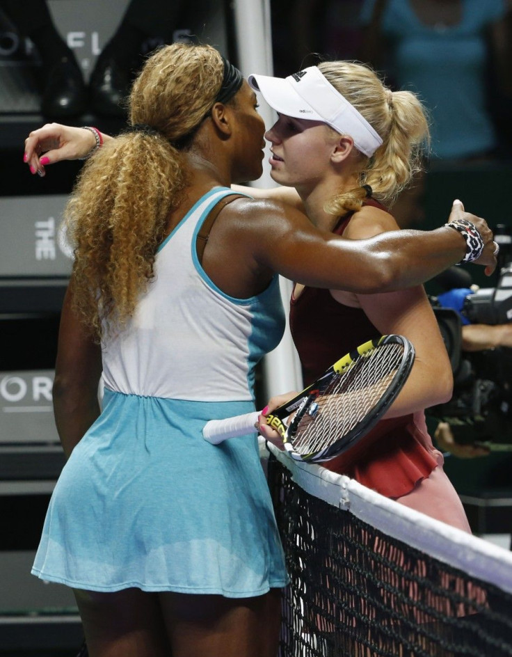Serena Williams of the U.S. is congratulated by Caroline Wozniacki of Denmark after their WTA Finals singles semi-final tennis match at the Singapore Indoor Stadium October 25, 2014. REUTERS/Edgar Su