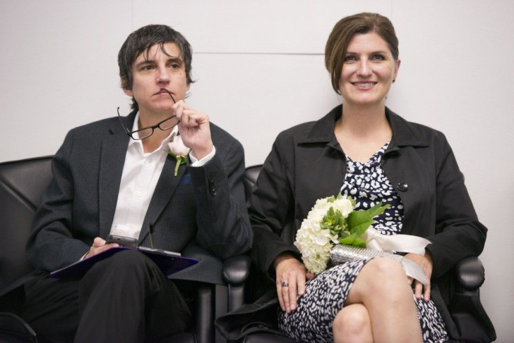Dawn Schmitz (L) and Holly Middleton (R) wait to apply for a marriage license at the Mecklenburg County Register of Deeds office in Charlotte, North Carolina, October 13, 2014. 