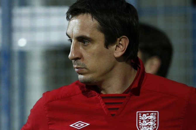 England assistant coach Gary Neville inspects the pitch before their 2014 World Cup qualifying soccer match against Montenegro at the City Stadium in Podgorica, March 26, 2013.