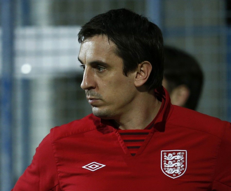 England assistant coach Gary Neville inspects the pitch before their 2014 World Cup qualifying soccer match against Montenegro at the City Stadium in Podgorica, March 26, 2013.