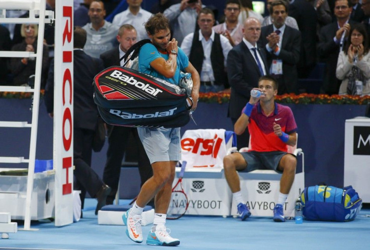 Spain's Rafael Nadal (front L) leaves after losing his match against Borna Coric (R) of Croatia at the Swiss Indoors ATP tennis tournament in Basel October 24, 2014. REUTERS/Arnd Wiegmann