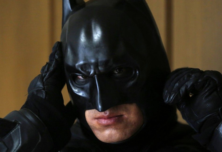 A 41-year-old man going by the name of Chibatman adjusts his mask
