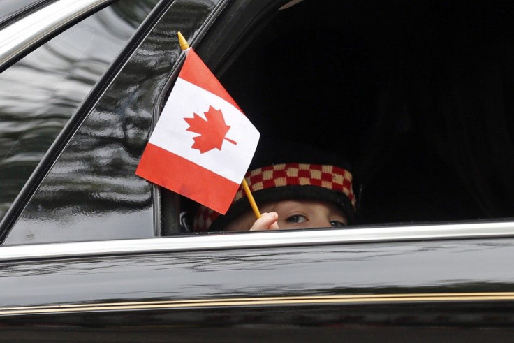 Marcus Cirillo, 5, waves a Canadian flag from a car window