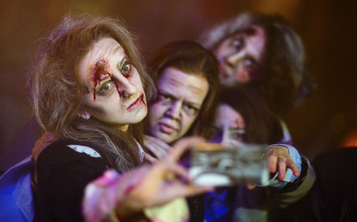 Actors take a selfie after a photocall for the new horror stunt show called Horror Nights at the Filmpark Babelsberg theme park in Potsdam October 16, 2014. REUTERS/Hannibal