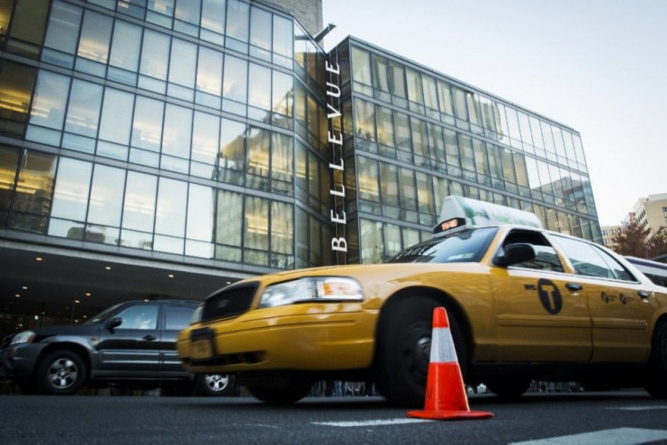 Traffic drives past Bellevue Hospital where Dr. Craig Spencer is currently recovering from Ebola in New York October 27, 2014. Federal health officials on Monday revamped guidelines for doctors and nurses returning home to the United States from treating 