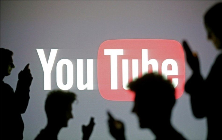 People Silhouetted Against Youtube Logo