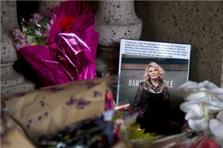 Flowers and a photo, which were left in tribute as part of a makeshift memorial, sit on the steps in front of Joan Rivers&#039; former residence in the Manhattan borough of New York