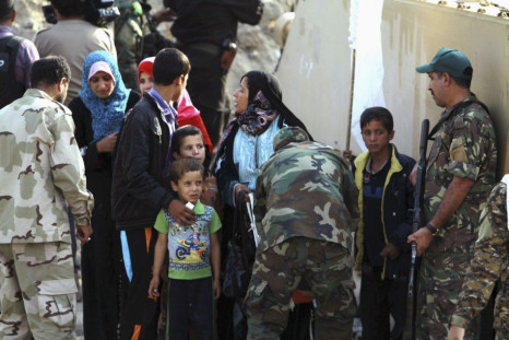 Iraqi families surrender to Shi&#039;ite fighters and Iraqi Army after they took control of Jurf al-Sakhar from Islamist State militants October 27, 2014. The families, who were in militant-held areas, surrendered to the army to be transported to safe are