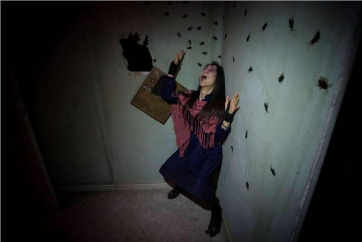 An actor depicting a woman terrorized by cockroaches in a derelict New York City apartment lobby