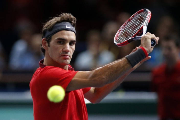 Switzerland's Roger Federer returns a shot during his men's singles tennis match against Lucas Pouille of France in the third round of the Paris Masters tennis tournament at the Bercy sports hall in Paris, October 30, 2014. REUTERS/Benoit Tessie