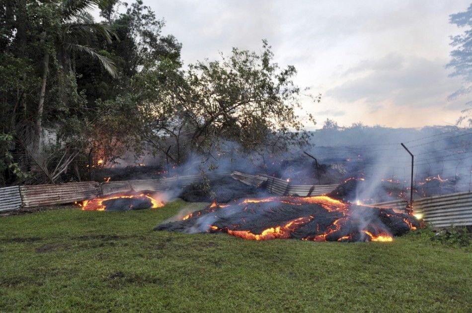 The lava flow from the Kilauea Volcano burns vegetation as it approaches a property boundary in a U.S. Geological Survey USGS image taken near the village of Pahoa, Hawaii, October 28, 2014. A slow-moving river of molten lava from an erupting volcano fl