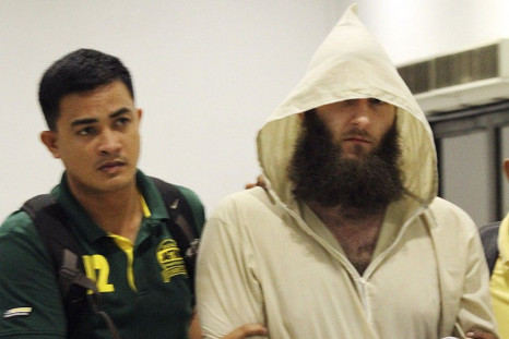 Robert Cerantonio (R), an Australian national and a Muslim convert, is escorted by police intelligence upon arrival at the domestic airport in Manila July 11, 2014.