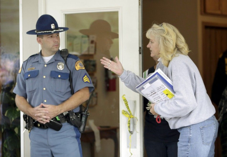 A state trooper stands watch at Shoultes Gospel Hall where people are helping students and family members reunite after a student opened fire at Marysville-Pilchuck High School, in Marysville, Washington October 24, 2014. The student opened fire in the ca