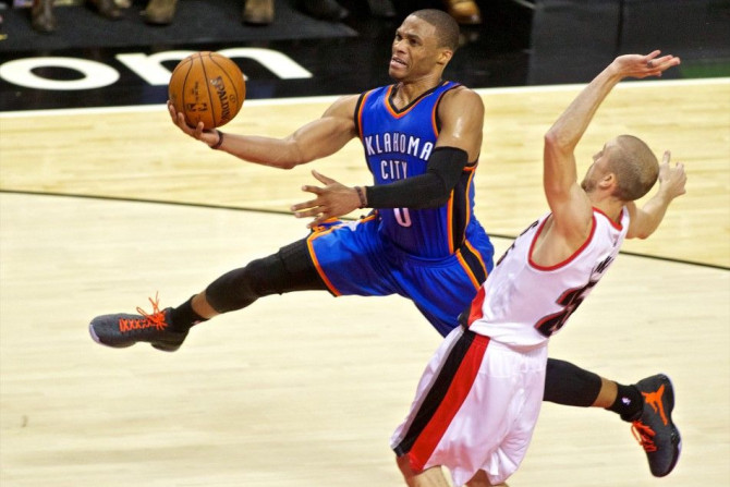 Oct 29, 2014; Portland, OR, USA; Oklahoma City Thunder guard Russell Westbrook (0) shoots over Portland Trail Blazers guard Steve Blake (25) during the third quarter at the Moda Center.