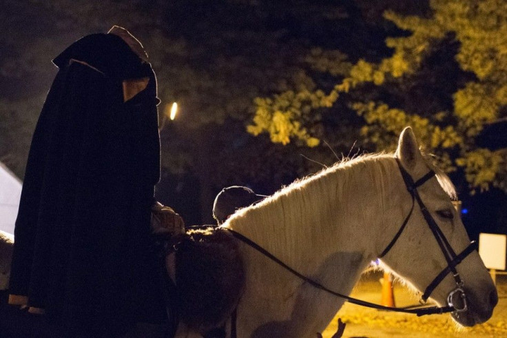 A costumed character referred to as the 'Headless Horseman' is seen at the start of the haunted trail known as the 'Horseman's Hollow' on the grounds of the historic Philipsburg Manor in celebration of Halloween in Sleepy Hollow, New York October 25, 2013