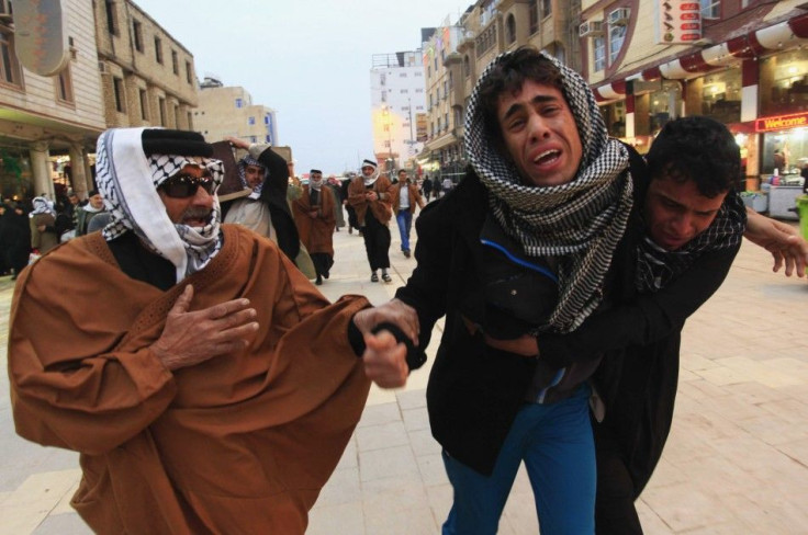 Mourners react during a funeral of an Iraqi soldier, who was killed during clashes in Ramadi, in Najaf, 160 km (99 miles) south of Baghdad, January 10, 2014.