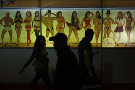 People attend the &quot;Sexo and Entertainment&quot; adult exhibition in Mexico City October 31, 2014. Exotic dancers, strippers and adult movie actors present new trends of the erotic and porn industry at the three-day event.