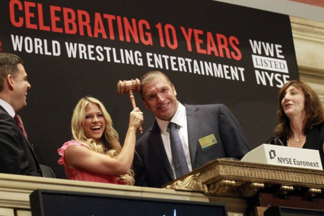 WWE wrestlers Kelly Kelly and Triple H pose for photographers prior to ringing the opening bell of the New York Stock Exchange October 27, 2010.